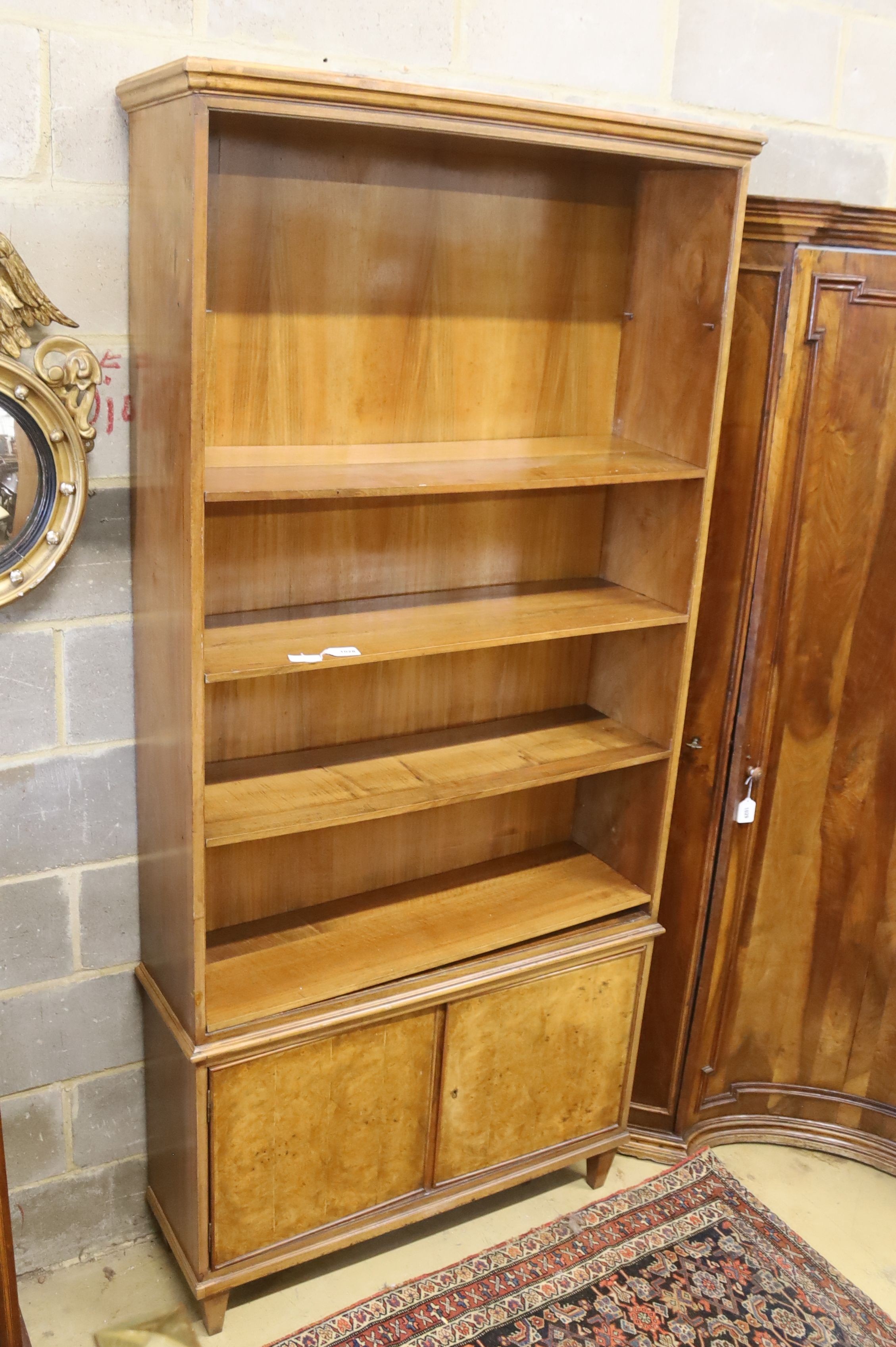 A mid century walnut open bookcase, width 102cm, depth 31cm, height 220cm